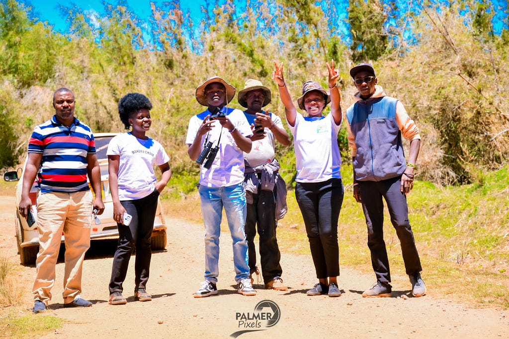 At Robby Nature Tours, adventurers strike a joyful pose